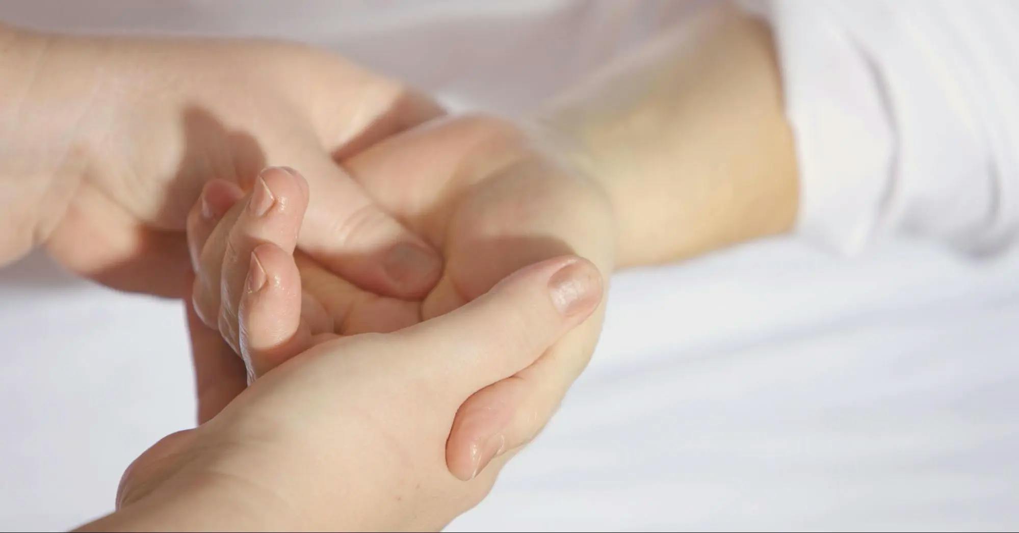 A person receiving a hand massage