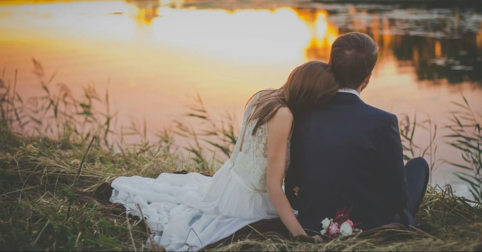 Married couple sitting near the lake